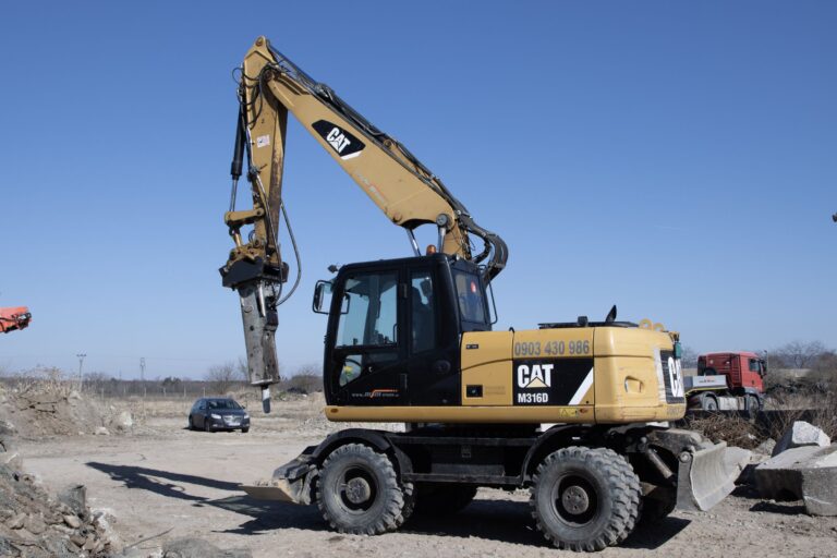 Kolesové rýpadlo CAT M316D s hydraulickým kladivom